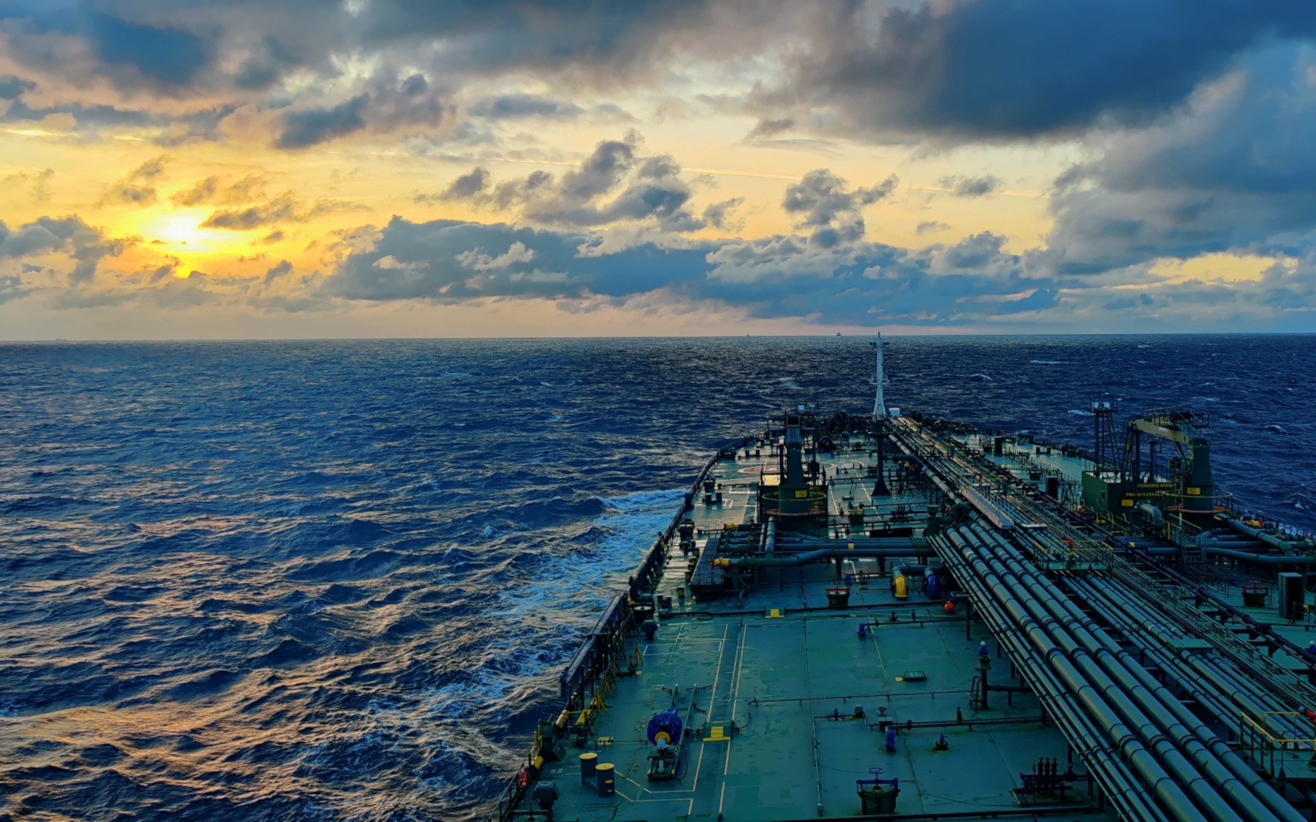 Hazmasters Shipping vessel out to sea at dusk.